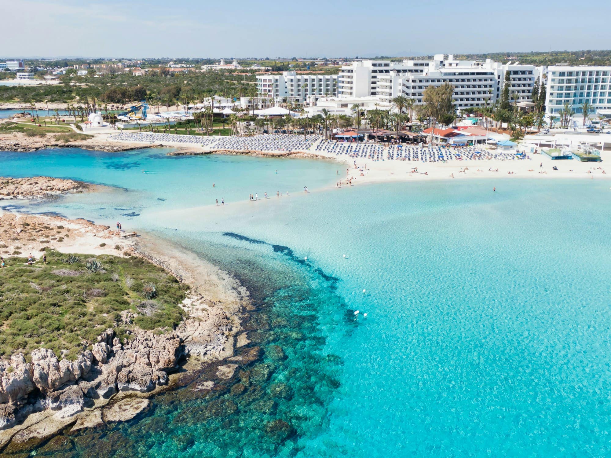 Crystal-clear turquoise water lapping a white sand bar at Nissi Beach, Cyprus
